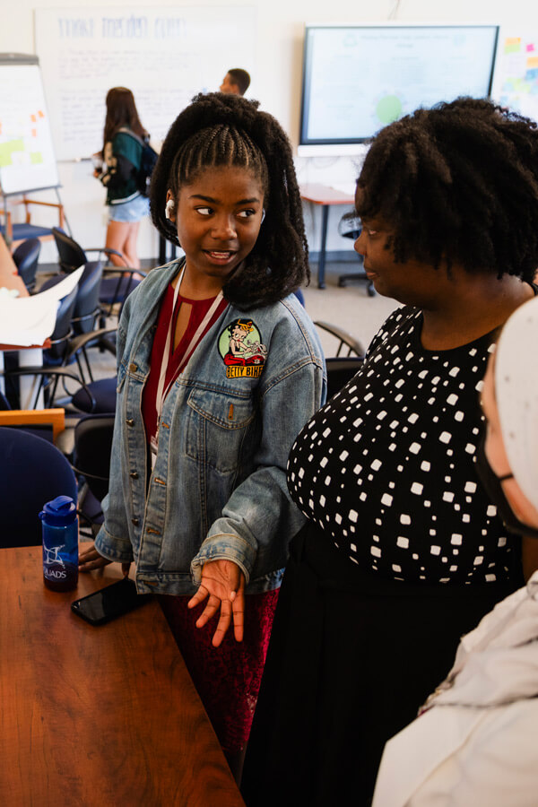 QUADS student presents her project to a mentor.