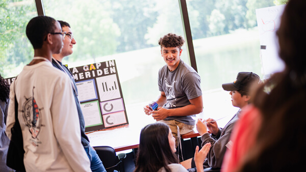 QUADS students discussing their projects on display at the North Haven campus.